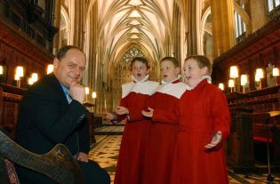 Headmaster Kevin Riley being entertained by three choristers